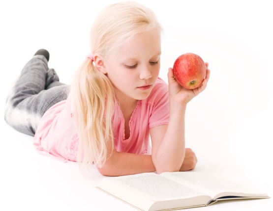 young student eating an apple while reading