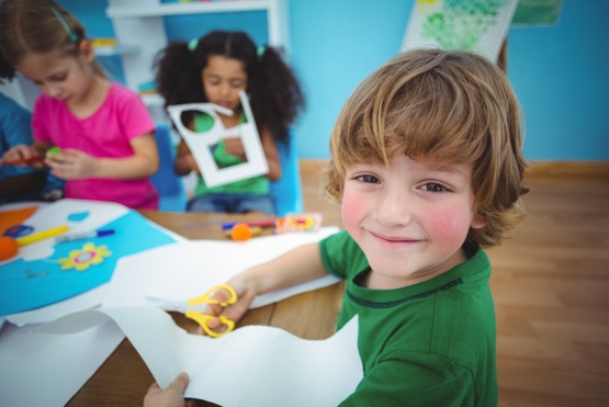 little boy participating in arts and crafts