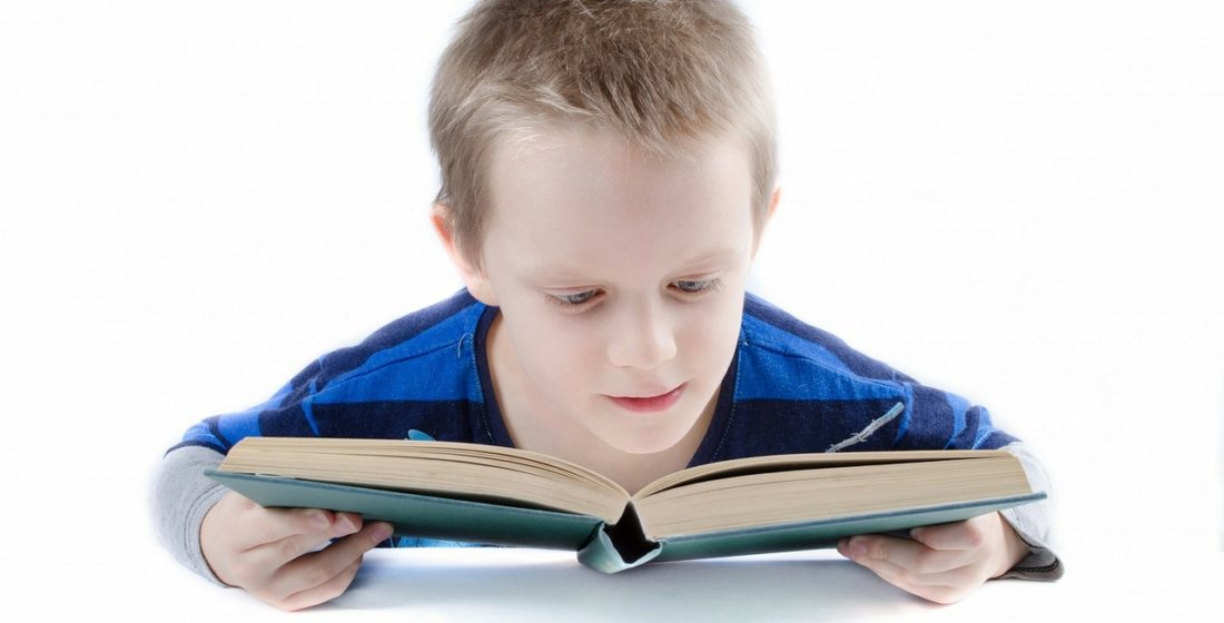 A boy with learning difficulties reads a book