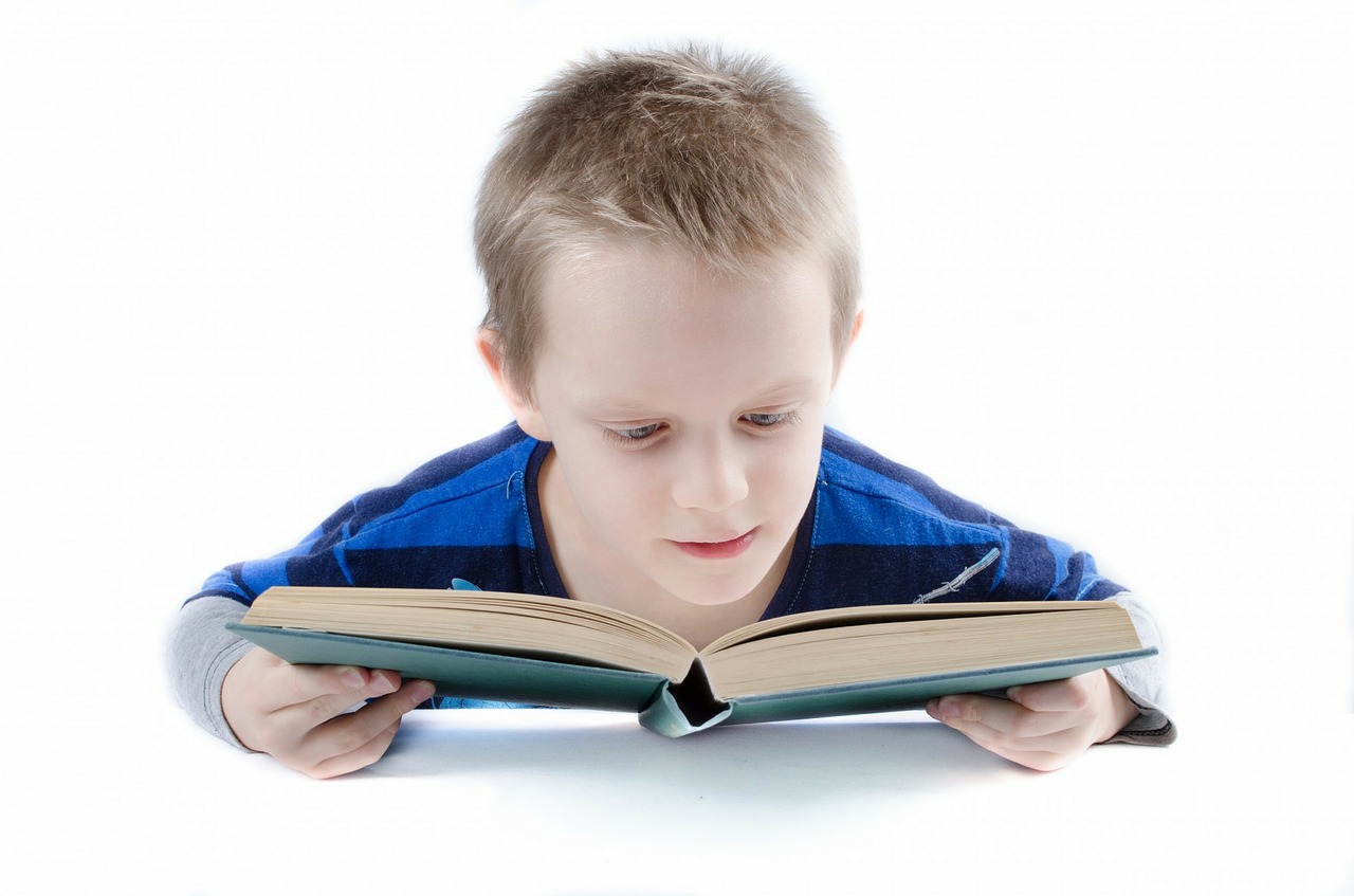 A boy with learning difficulties reads a book