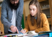 Student working on their homework with a tutor