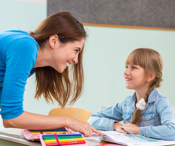 professional tutor teaching little girl